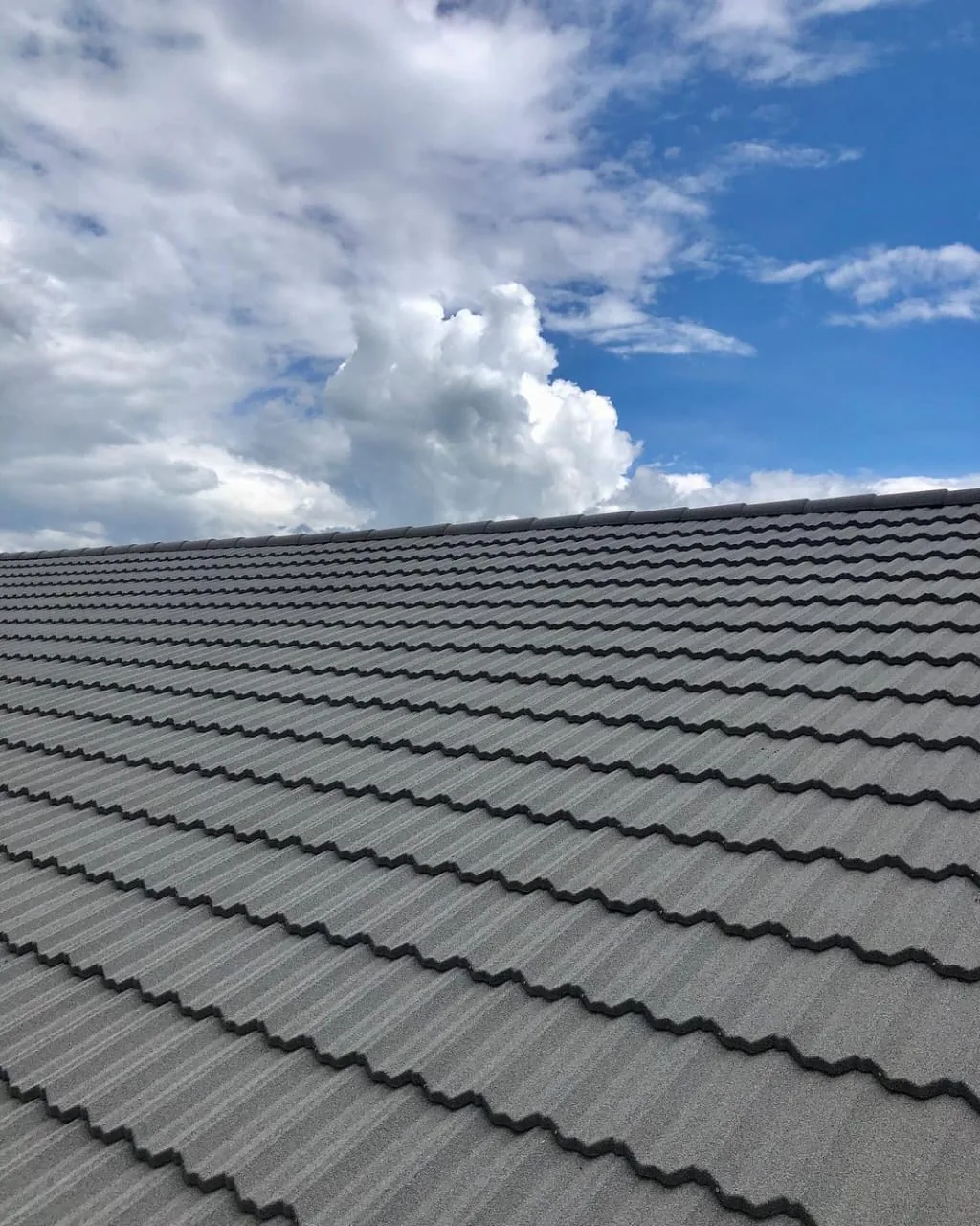 Stone-coated roof against a blue sky