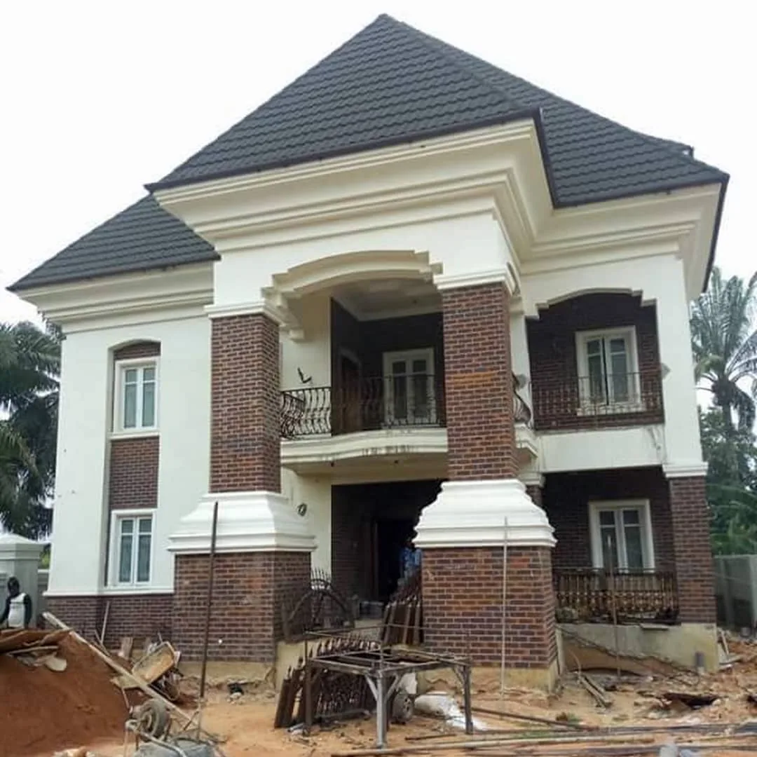 Two-storey house with a black stone-coated roof