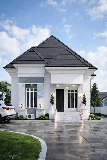 White bungalow with a shingle roof